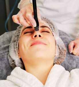 Woman Getting Facial Hydro Microdermabrasion Peeling Treatment At Cosmetic Beauty Spa Clinic. Hydra Vacuum Clea